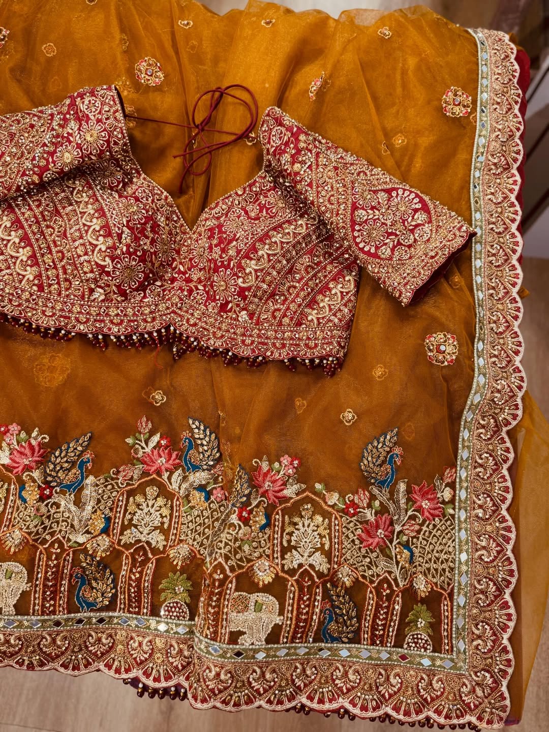 Rajwadi Luxury Cinnamon Net Saree with zari, sequins and stone work, intricately woven into rich motifs and Fully Stitched Readymade Embroidered Blouse (SC77555)